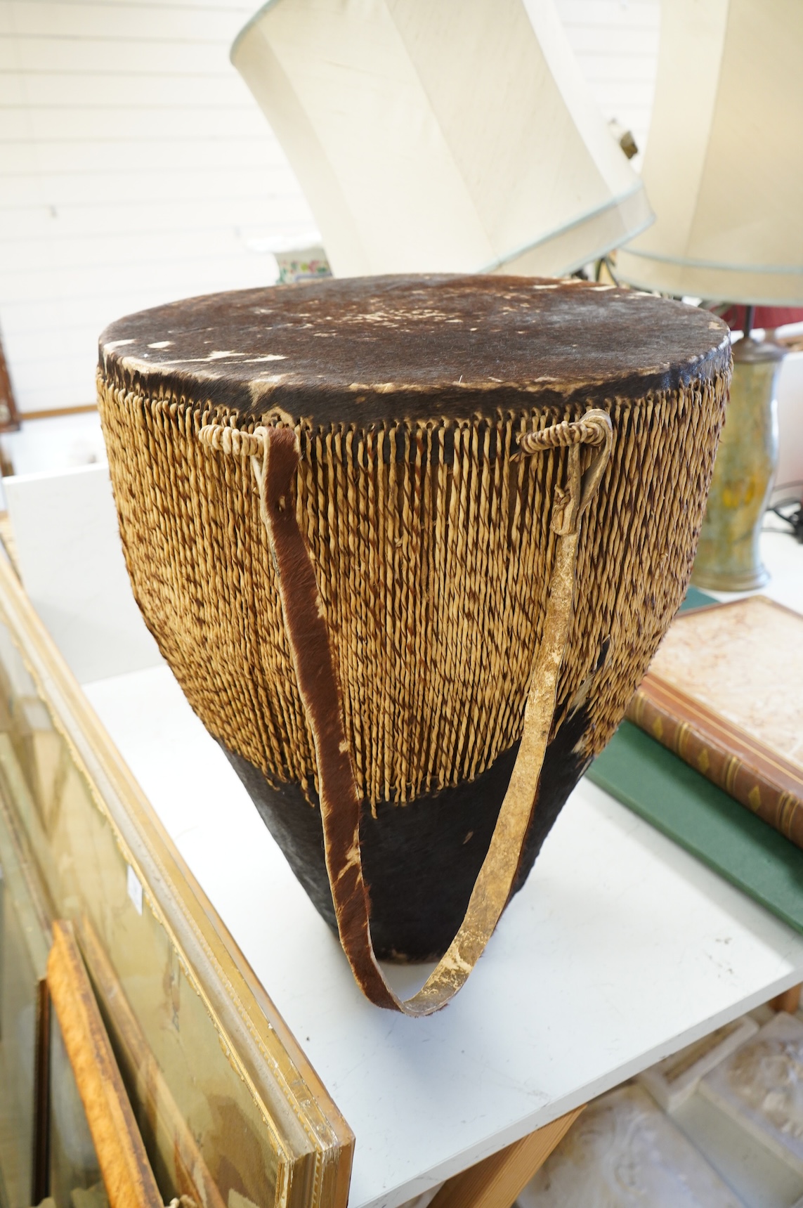 An African drum with a hide skin and gut stretchers, the body of the drum also covered with hide, diameter of the drum 46cm, the height 60cm